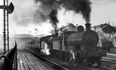 A steam train passing on the railway
